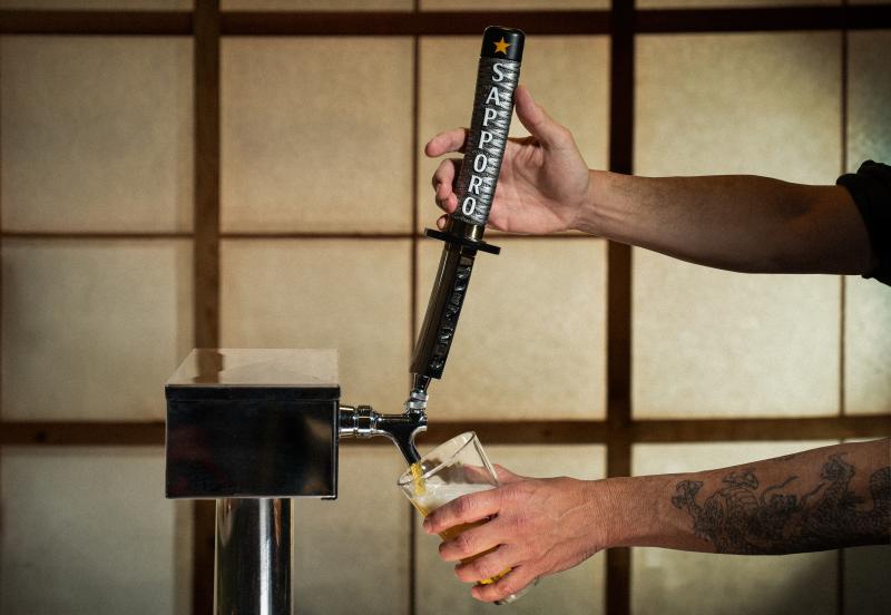 Sapporo Tap Handle pouring beer